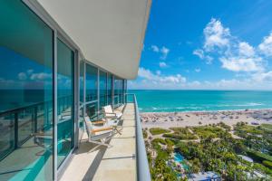 an oceanfront balcony with chairs and the beach at Oceanfront Private Condo at The Setai -2208 in Miami Beach
