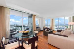 a living room with a couch and a table at Oceanview Private Condo at The Setai -2402 in Miami Beach