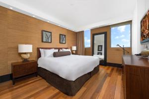 a bedroom with a large bed and a desk at Oceanview Private Condo at The Setai -2402 in Miami Beach