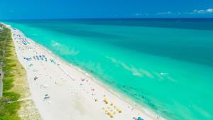 an overhead view of a beach with a group of people at Oceanview Private Condo at The Setai -2401 in Miami Beach