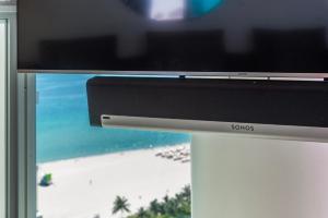 a sony tv sitting on a table next to a beach at Oceanview Private Condo at The Setai -2604 in Miami Beach