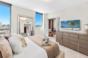 a living room with a bed and a tv at Oceanview Private Condo at The Setai -2604 in Miami Beach