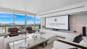 a living room with a large screen in a building at Oceanfront Private Penthouse Condo at The Setai -3909 in Miami Beach