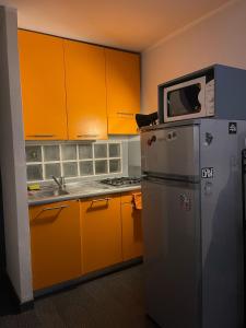 a kitchen with a microwave on top of a refrigerator at City Center Heart in Turin