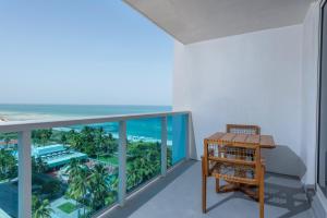 a room with a balcony with a view of the ocean at Oceanview Private Condo at 1 Hotel & Homes -915 in Miami Beach