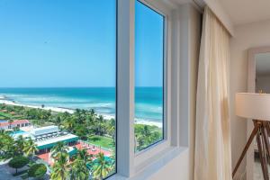 a room with a window with a view of the beach at Oceanview Private Condo at 1 Hotel & Homes -915 in Miami Beach