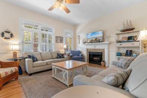 a living room with a couch and a fireplace at A 4 Bedroom House in Gated Litchfield By the Sea in Pawleys Island