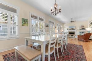 a dining room with a white table and chairs at A 4 Bedroom House in Gated Litchfield By the Sea in Pawleys Island