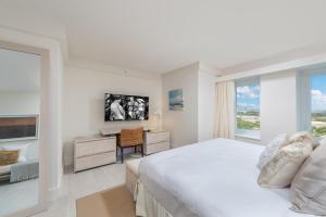 une chambre blanche avec un lit, un bureau et une fenêtre dans l'établissement Luxurious Private Condo at 1 Hotel & Homes -1445, à Miami Beach