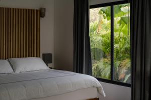 A bed or beds in a room at The Bohemian Lagarto