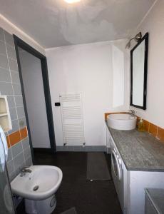 a bathroom with a white sink and a toilet at City Center Heart in Turin