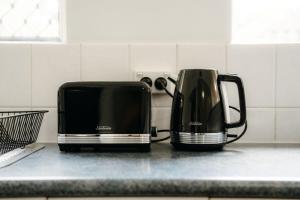 two black toasters sitting on a kitchen counter at Unit 1, Rocky CBD in Rockhampton