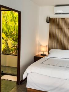 A bed or beds in a room at The Bohemian Lagarto