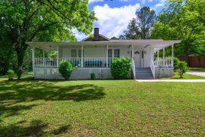 a white house with a porch on a lawn at Hueytown Haven nearby Alabama Splash Adventure in Bessemer