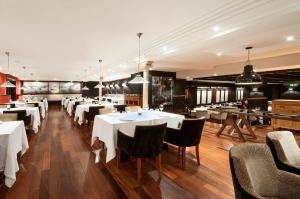 a dining room with white tables and chairs at Hotel 1898 in Barcelona