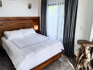 A bed or beds in a room at The Bohemian Lagarto