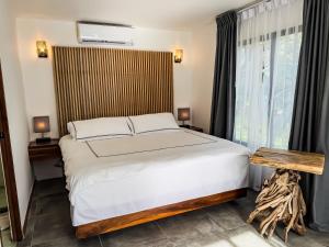 A bed or beds in a room at The Bohemian Lagarto