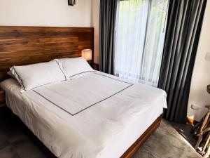 A bed or beds in a room at The Bohemian Lagarto
