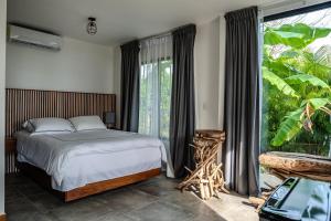 A bed or beds in a room at The Bohemian Lagarto