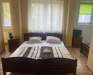 a bedroom with a large bed in a room at Zakątek Pensjonat in Wisła