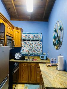 a kitchen with a sink and a counter top at Montego Bay, Ironshore Luxury Studio BLUE ROOM in Montego Bay