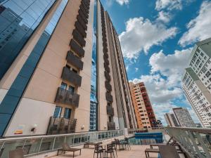 a balcony of a building with tables and chairs at FLAT S4 Hotel in Brasilia