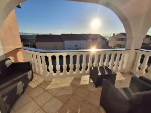 a balcony with a white railing and a view at Blue Ivy in Vrh