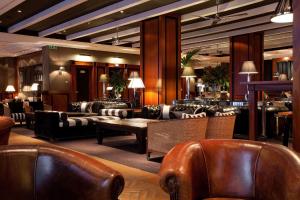 a lobby with couches and a table and chairs at Hotel 1898 in Barcelona