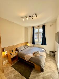 a bedroom with a bed and a window at Stay 45A in London