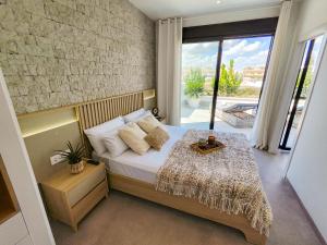 a bedroom with a bed and a large window at Villa Murcia - Private heated pool & jacuzzi in Santiago de la Ribera +107 photos