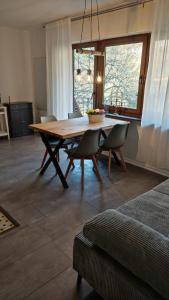 a dining room with a wooden table and chairs at Bergblick in Zell an der Mosel +10 photos