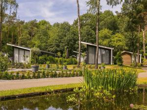 a house in a garden with a pond at Chalet in Zell am See near Ski Slope in Markelo