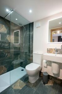 a bathroom with a toilet and a sink and a shower at Dalecote Barn Bed & Breakfast in Ingleton  +42 photos