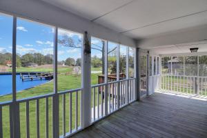 an empty porch with a view of the water at Our Happy Place - Pet friendly & waterfront! in Deep Hole