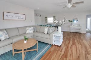 a living room with a couch and a table at Our Happy Place - Pet friendly & waterfront! in Deep Hole