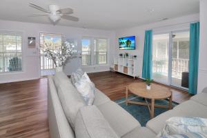 a living room with a couch and a table at Our Happy Place - Pet friendly & waterfront! in Deep Hole