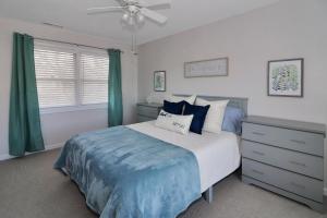 a bedroom with a bed and a ceiling fan at Our Happy Place - Pet friendly & waterfront! in Deep Hole +31 photos
