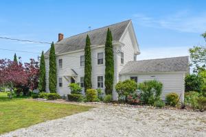 a white house with trees and a driveway at Oyster Catcher - Pet friendly & deep water access! in Deep Hole