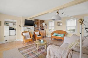 a living room with a couch and chairs and a table at Oyster Catcher - Pet friendly & deep water access! in Deep Hole