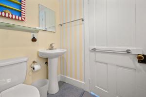 a bathroom with a white toilet and a sink at Oyster Catcher - Pet friendly & deep water access! in Deep Hole +67 photos