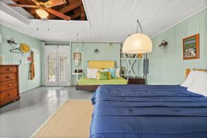 a bedroom with a blue bed in a room at Oyster Catcher - Pet friendly & deep water access! in Deep Hole