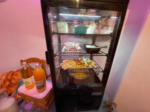 an open refrigerator with food inside of it at Le Matagot Auberge-Restaurant in Mazeyrat-Aurouze +20 photos