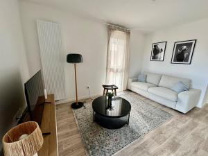 a living room with a couch and a table at Petit havre de paix ! in Carcans