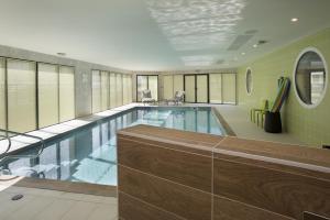 a large swimming pool in a building at DOMITYS - Le Pupitre d'Or in Saint-James