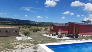 a house with a swimming pool next to a building at Las Secretas in La Cumbre