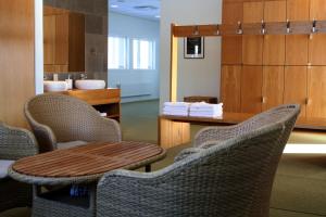 a room with chairs and a table and a bathroom at Sand Golf Club in Bankeryd