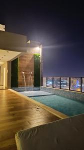 a swimming pool in a building with a view of the city at Central Relax Apartment in Encarnación