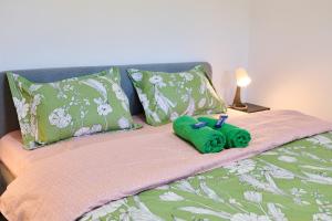 a bed with a green towel and two pillows at Old Town Retreat Studio 9 in Bucharest
