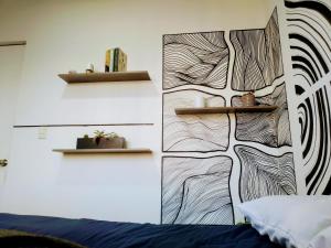 a bedroom with a wall with a drawing on it at Magnífica habitación rodeada de arte en Centro Histórico in Mexico City