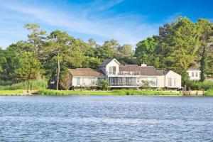 an image of a house from the water at Poole's Cove - Waterfront; Main Street! in Deep Hole